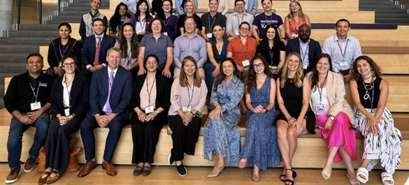 Cohort group photo on the Global Hub stairs at Kellogg
