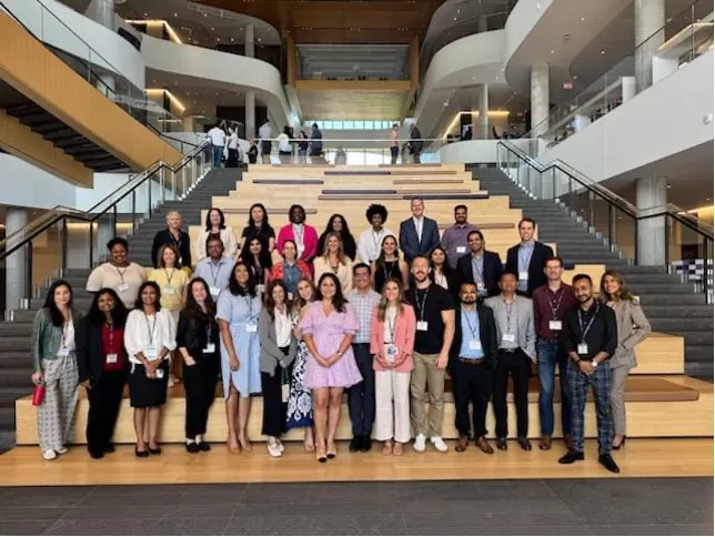 Group photo on the grand staircase at Kellogg's Global Hub
